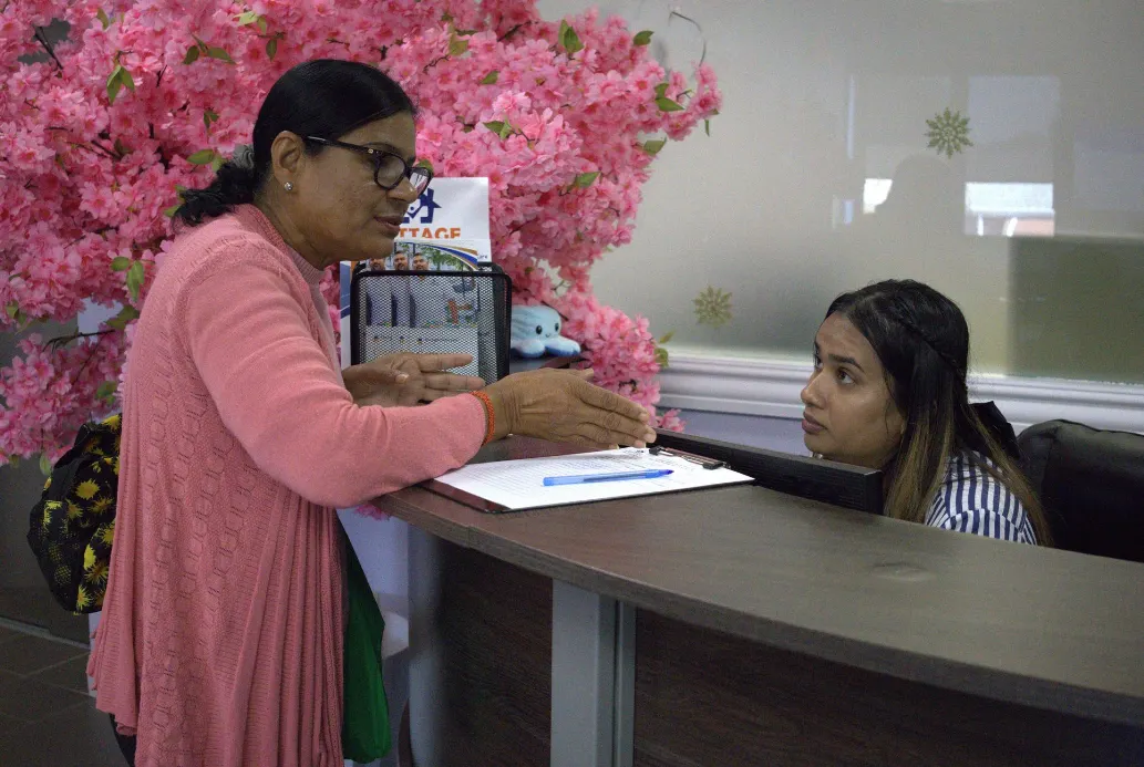Caregiver assisting a client with daily living at home.